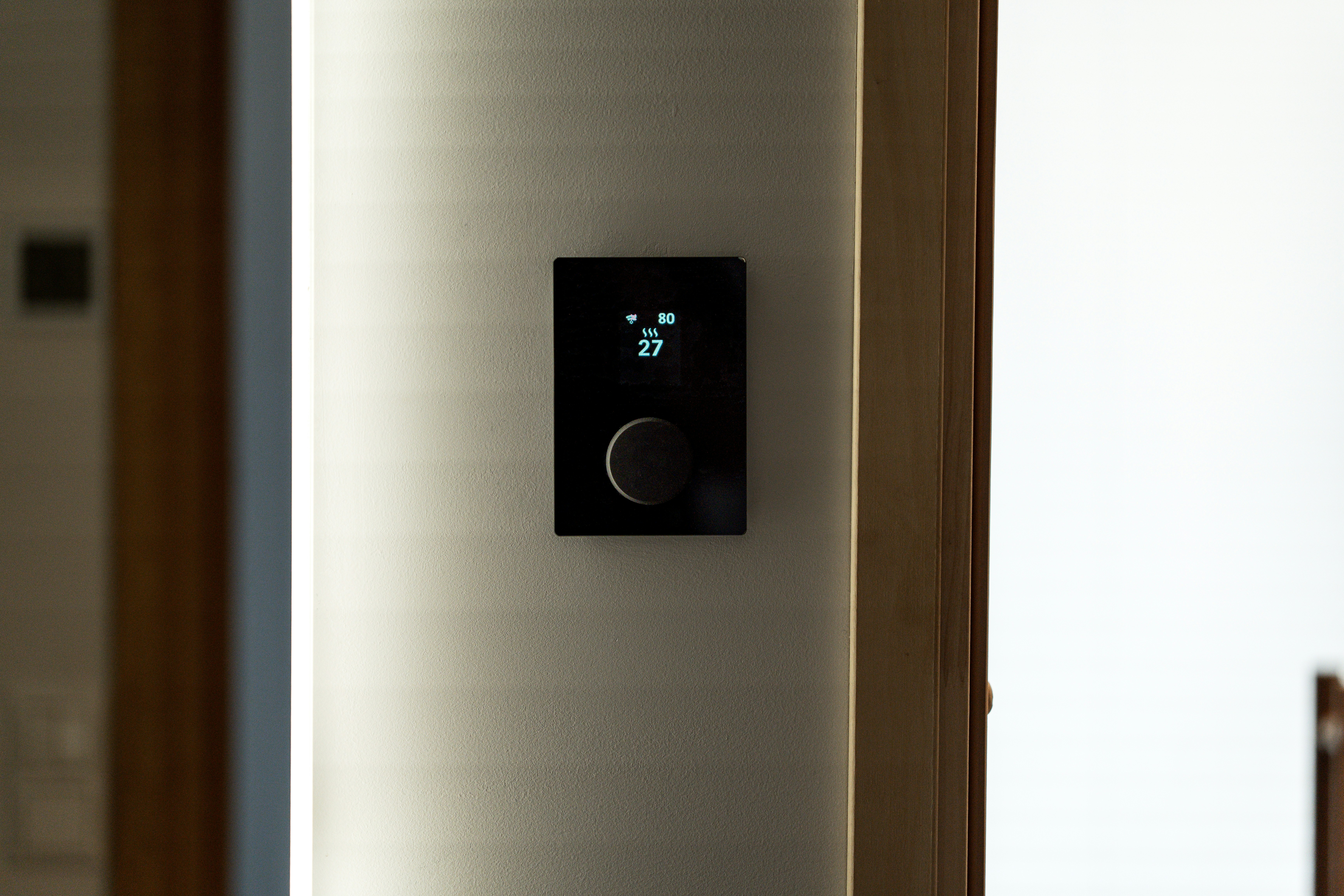 Modern thermostat on a wall inside a home